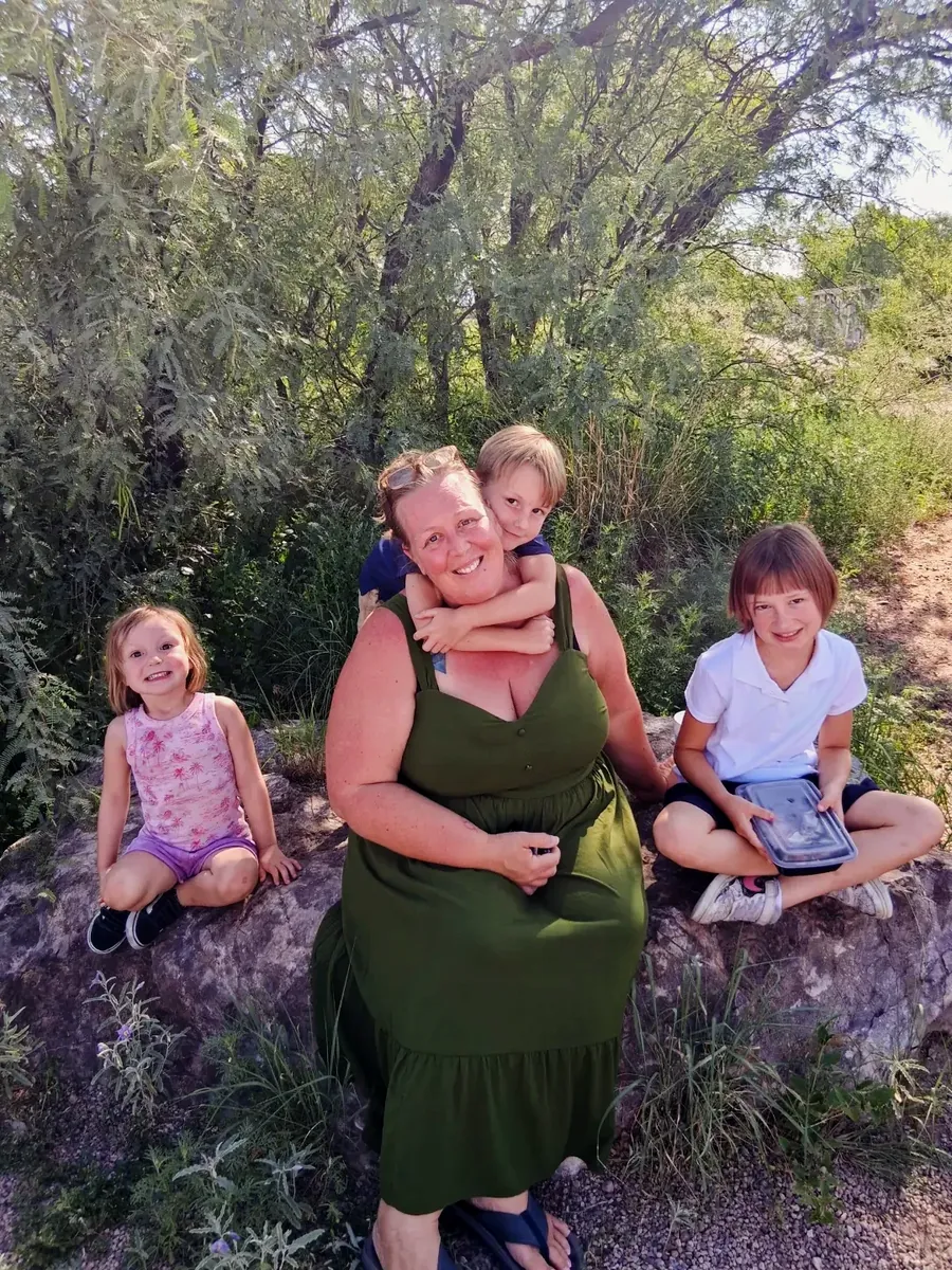 Audrey Talbert, owner of Green Guru Cleaning, with her kids in the Tucson desert